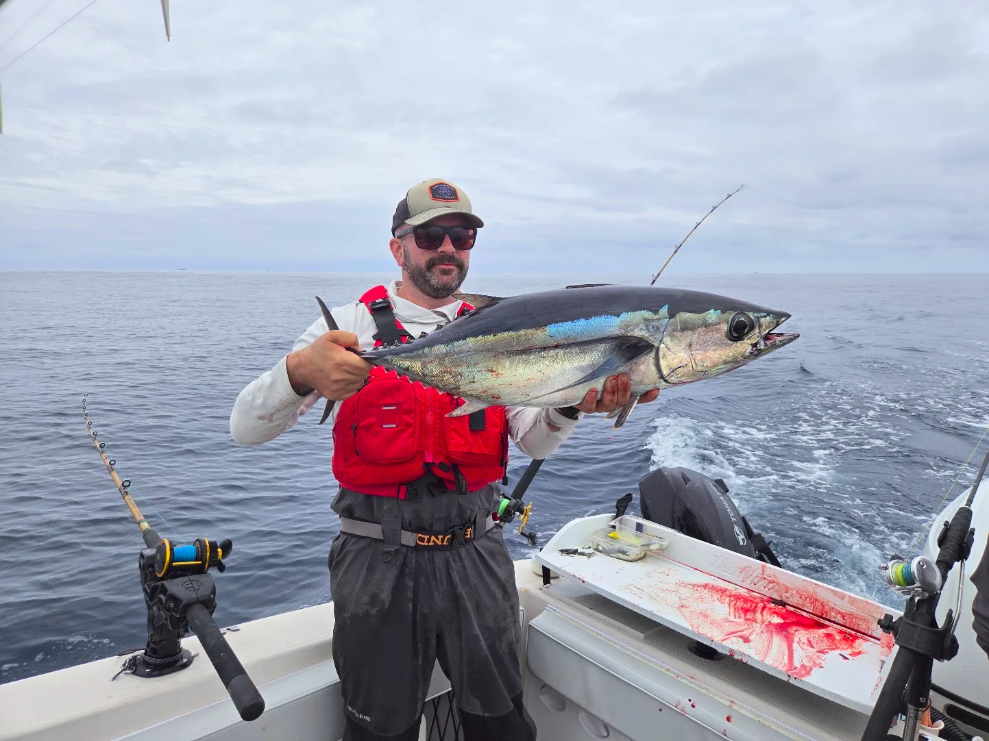 The PNW Tuna Map builder holding an albacore aboard a fishing boat